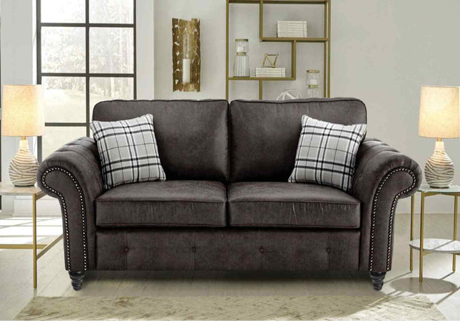 Oakmont 2 seater sofa - charcoal,  faux leather  two seater sofa is soft-to-the-touch and cosy, rounded arms with button detail and  metal studded up the front of the arm. 