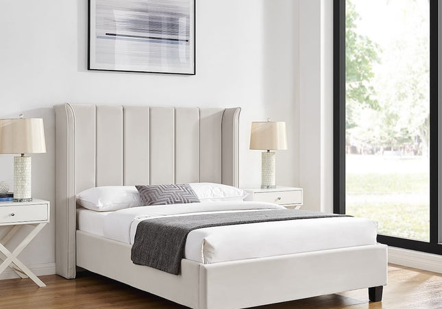 A double or king-size bed with a winged headboard, upholstered in white velvet,