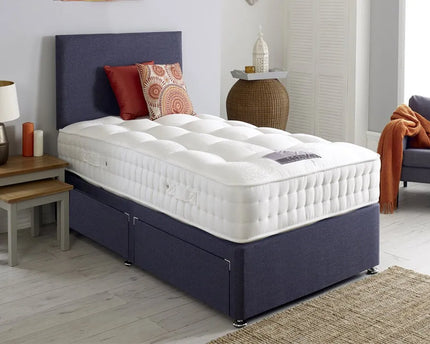 A single divan bed with a plain headboard, upholstered in charcoal color, 