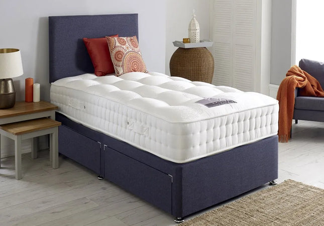 A single divan bed with a plain headboard, upholstered in charcoal color, 