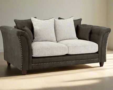 Bella Grey 2 seater sofa . Crafted with a blend of polyester and faux leather. scatter back cushions. removable cushions. stud detail around the frame 