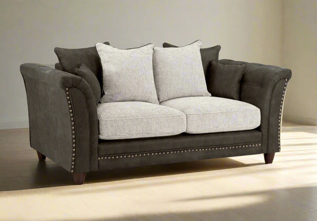 Bella Grey 2 seater sofa . Crafted with a blend of polyester and faux leather. scatter back cushions. removable cushions. stud detail around the frame 