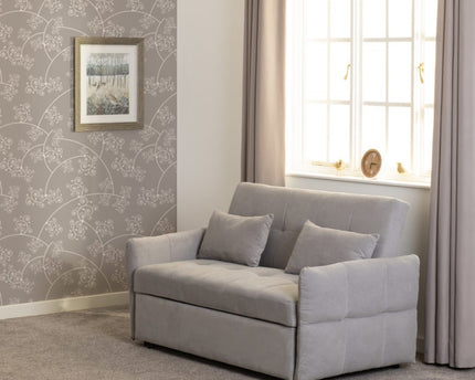Gray sofa bed with cushions and button detail to the seats