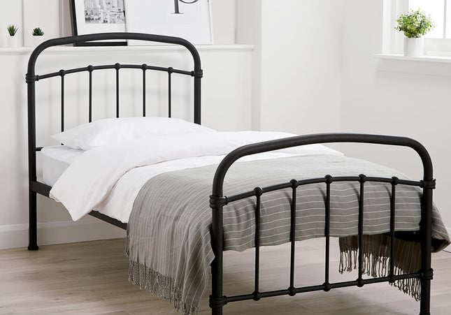 A single-sized black metal bed frame with a headboard and footboard