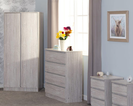 Gray bedroom furniture set with a wardrobe, chest of drawers, and nightstand.