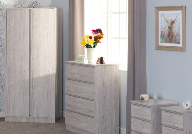 Gray bedroom furniture set with a wardrobe, chest of drawers, and nightstand.