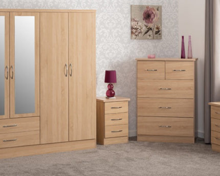 Wooden bedroom furniture set including a wardrobe, chest of drawers, and nightstands.