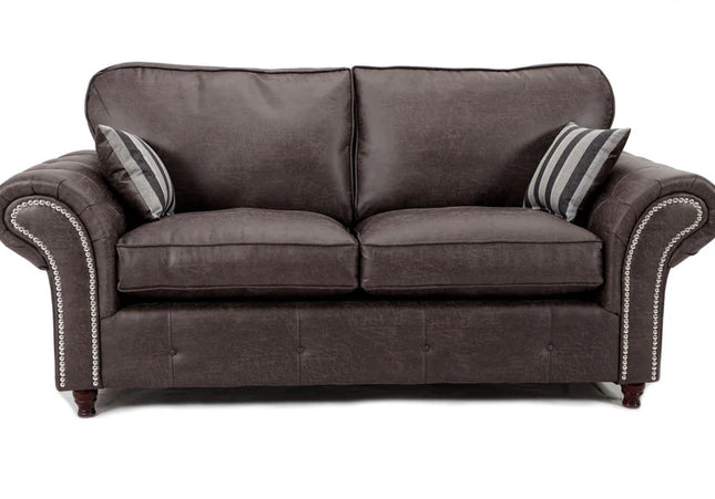 Oakmont 3 seater sofa - charcoal,  faux leather three seater sofa is soft-to-the-touch and cosy, rounded arms with button detail and  metal studded up the front of the arm. 