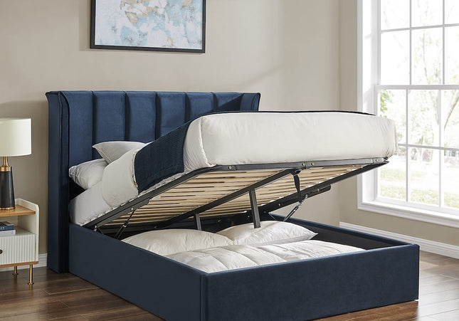 A Double navy ottoman bed with a winged headboard and storage space beneath, 