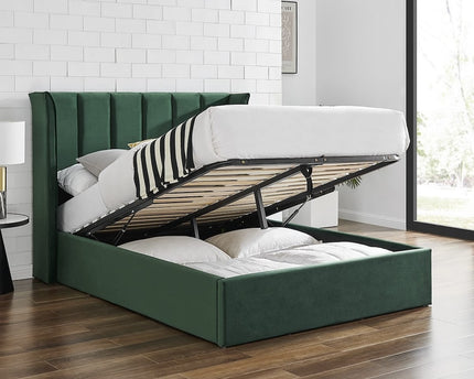Emerald green velvet ottoman bed with a winged headboard and storage space beneath, 