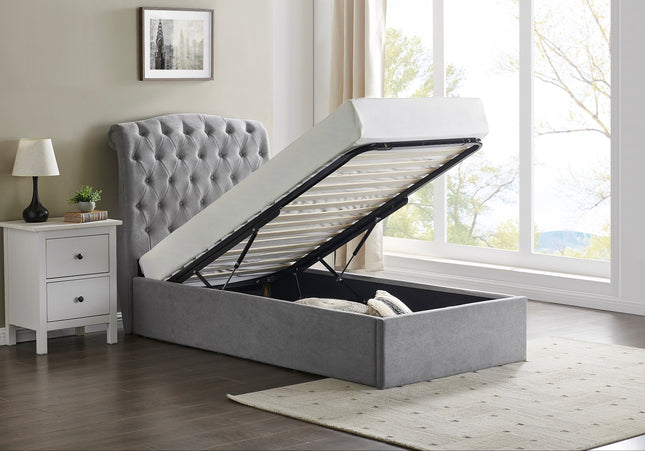 A single-sized Rosa ottoman bed with a button style headboard in light grey, the bed is lifted to show the storage space inside.