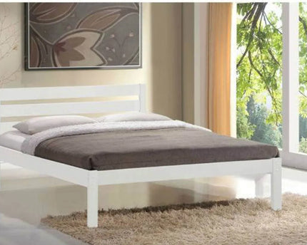 A double bed with a white frame and paneled headboard,