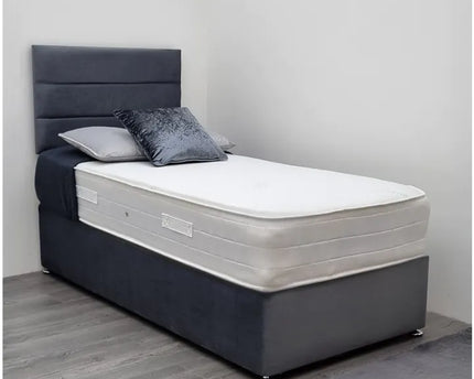 A single divan bed with a gray fabric headboard and base, featuring a white mattress.