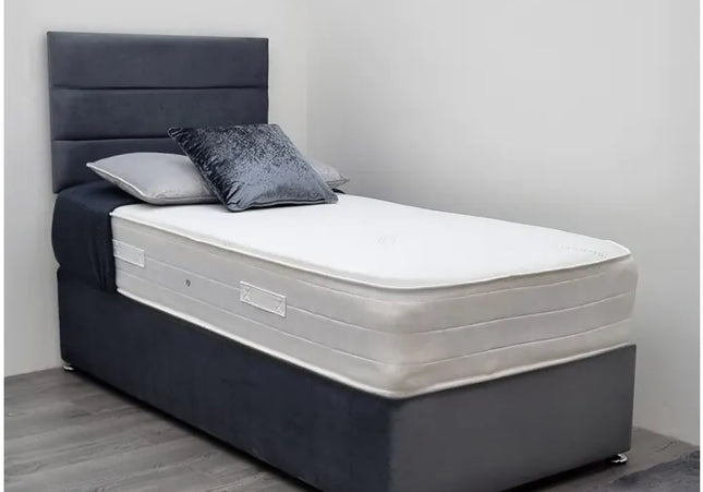 A single divan bed with a gray fabric headboard and base, featuring a white mattress.