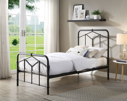 A single black metal bed frame with a white mattress on it,